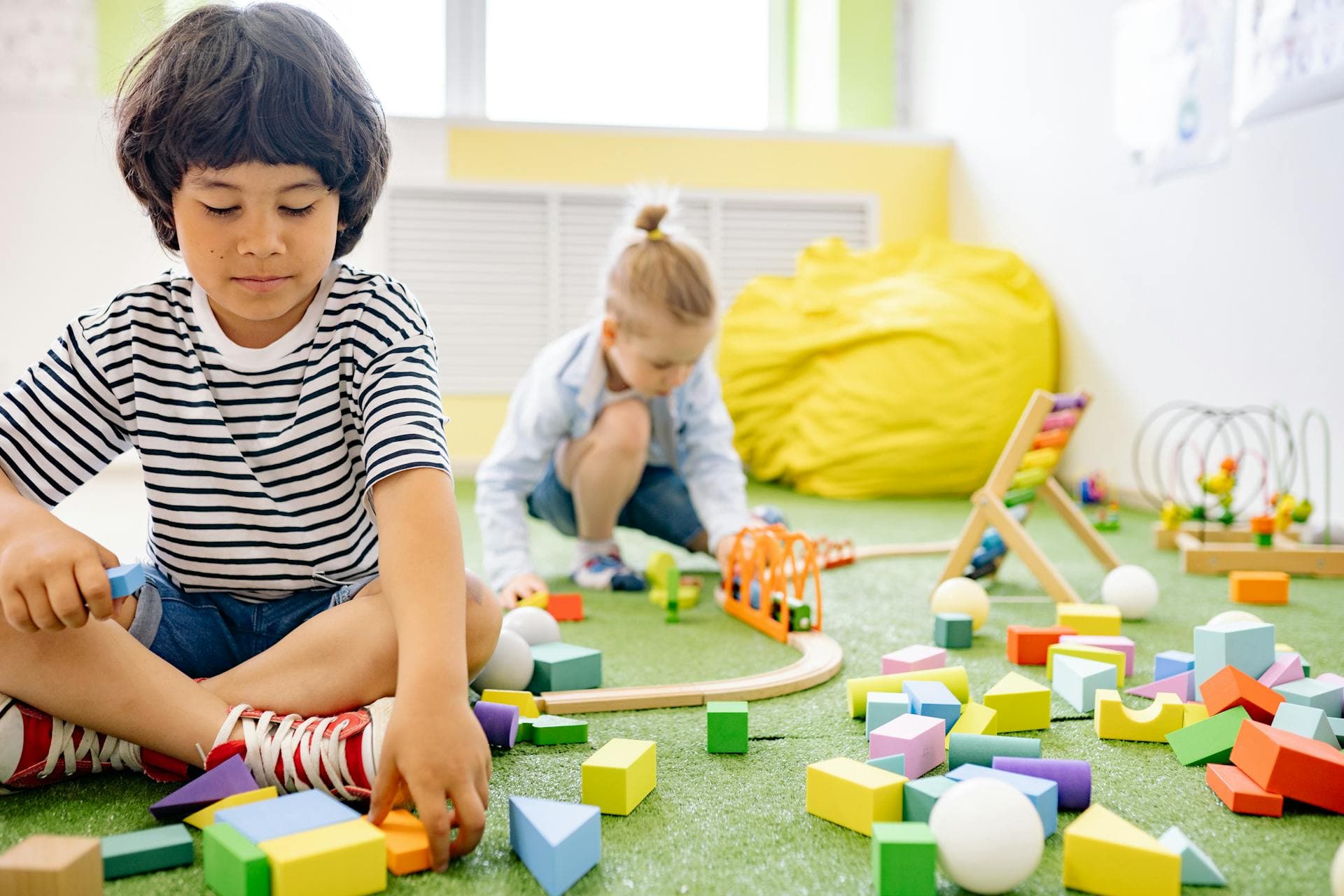 Children playing with blocks on a classroom floor