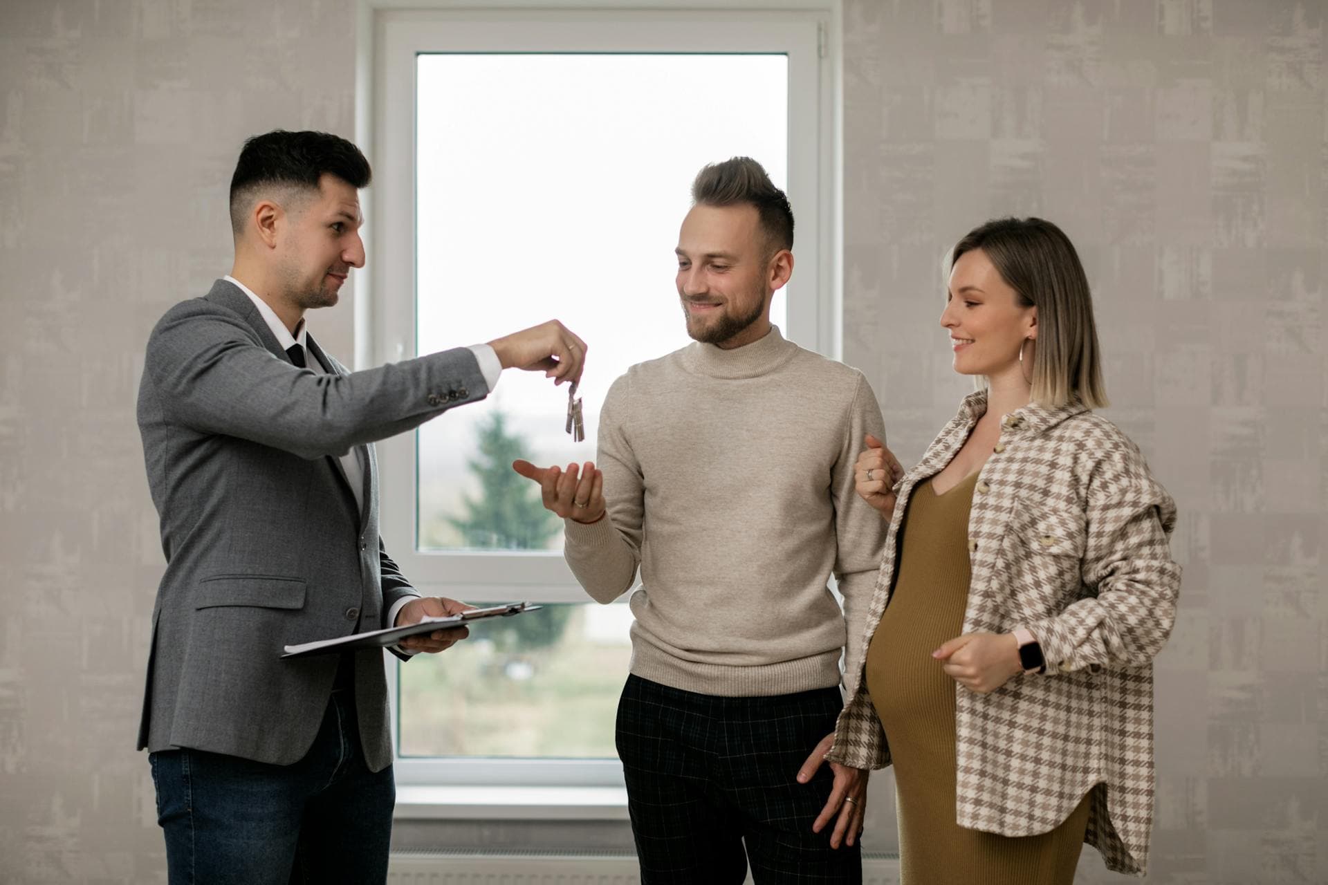 Realtor handing keys to homebuyers after radon test in Marietta GA
